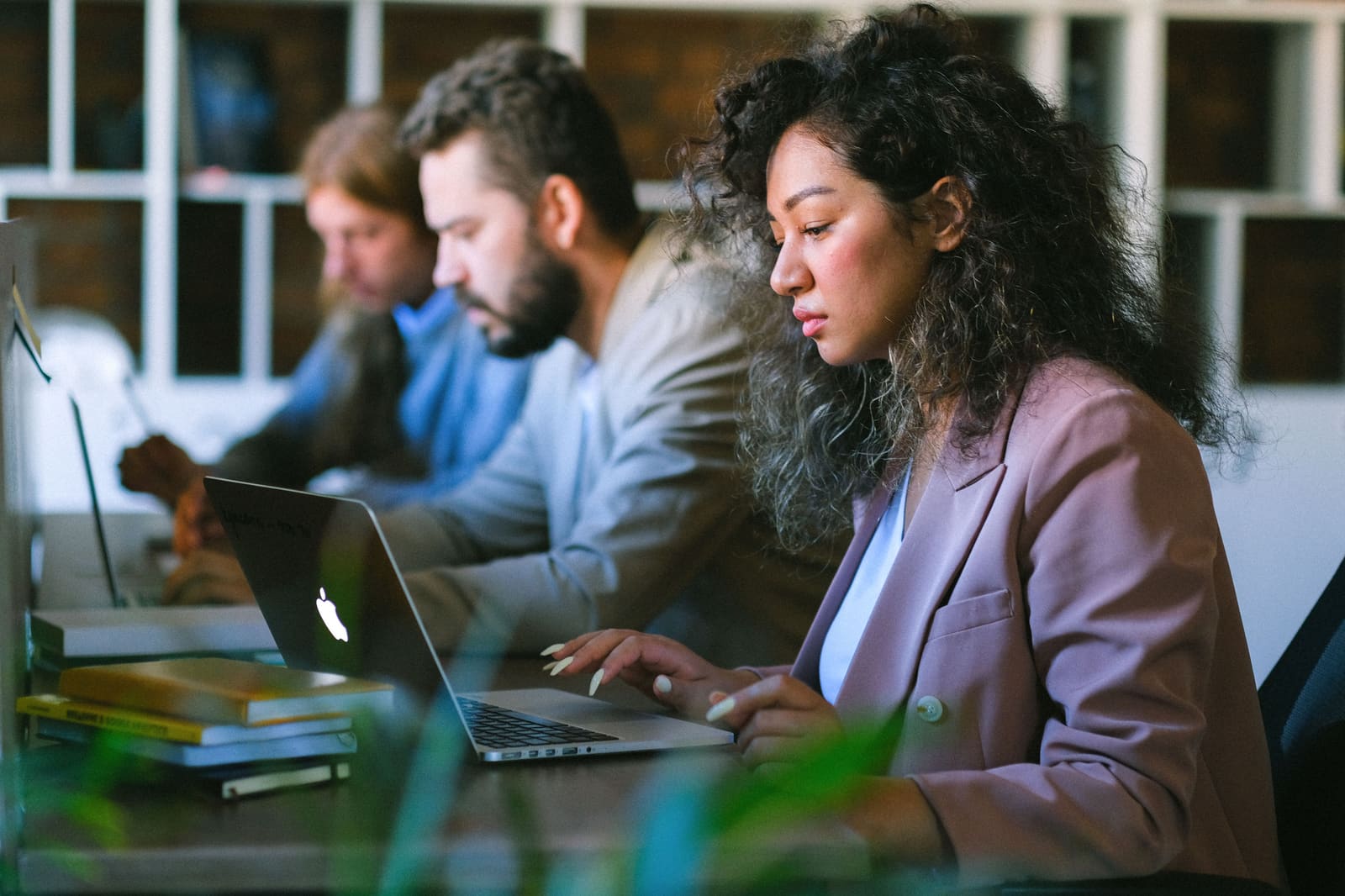 Colleagues working together on laptops in an office